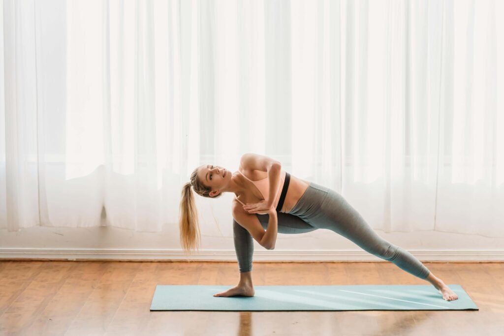 A woman performing a glute bridge exercise on a yoga mat, a key part of the no-equipment full-body home workouts for busy moms